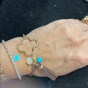 Gold Tone Four Leaf Motif Charm Bracelet.